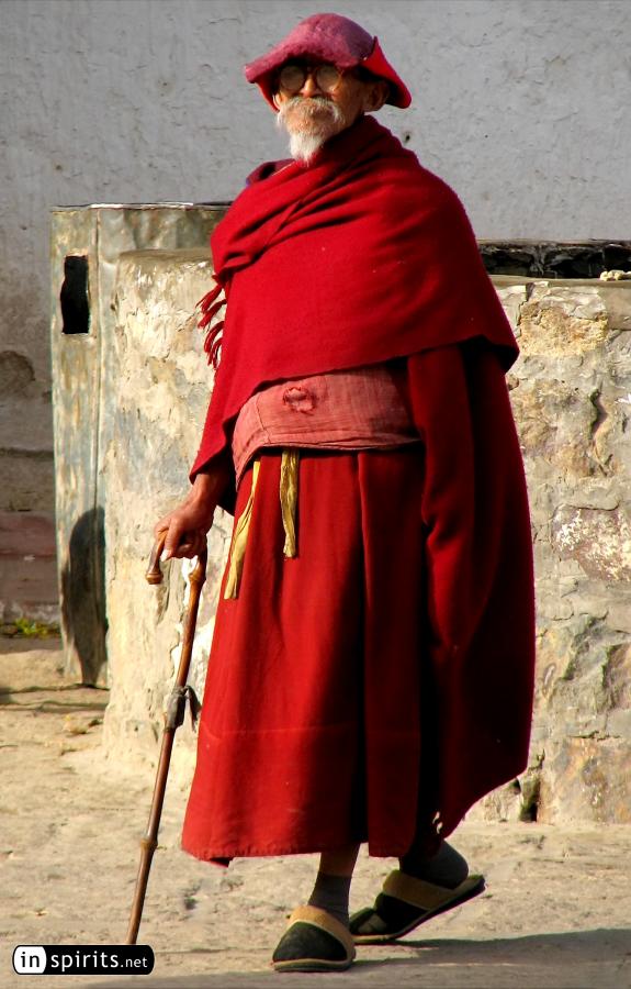 Tibetan pilgrim with a unique hat marches on