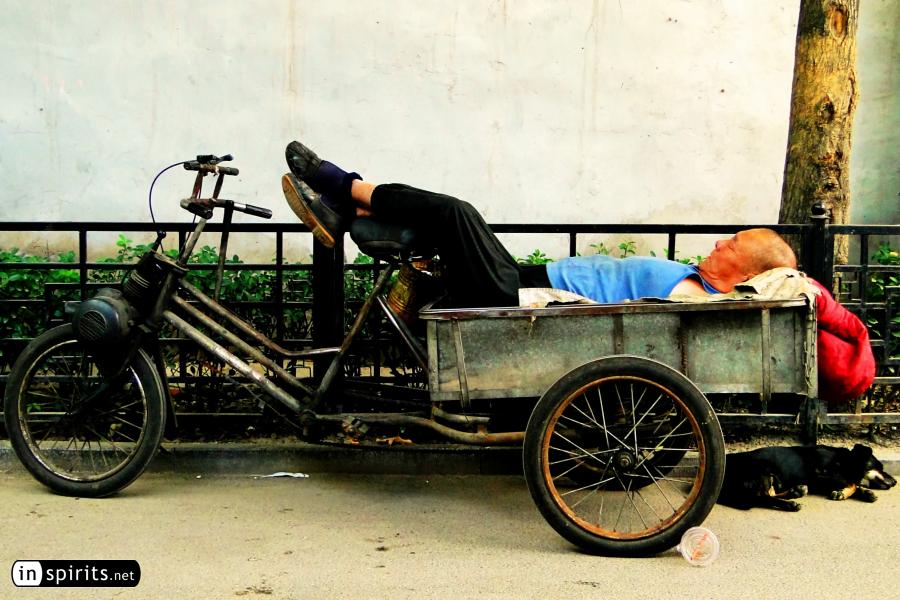 Napping on a tricycle in a Beijing hutong
