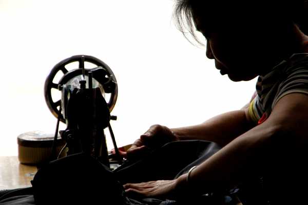 Chinese Woman on a Sewing Machine in Guangxi