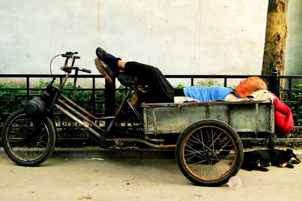 Napping on a tricycle in a Beijing hutong